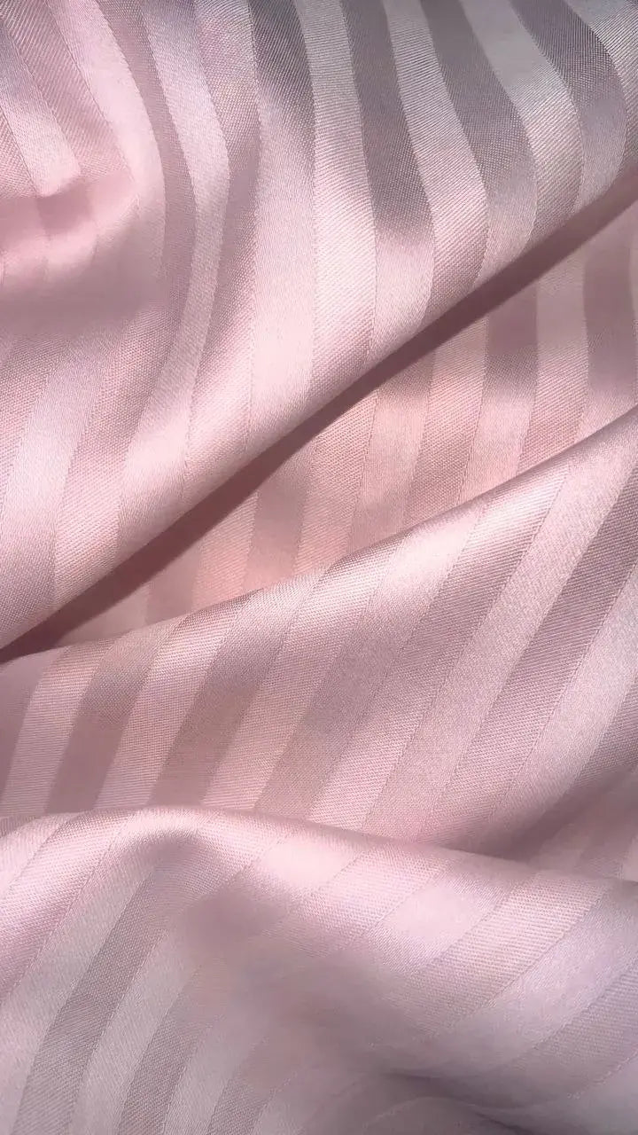 Close-up of pink stripe sateen bedding “Strawberry Soufflé”, luxury cotton fabric with silky sheen.