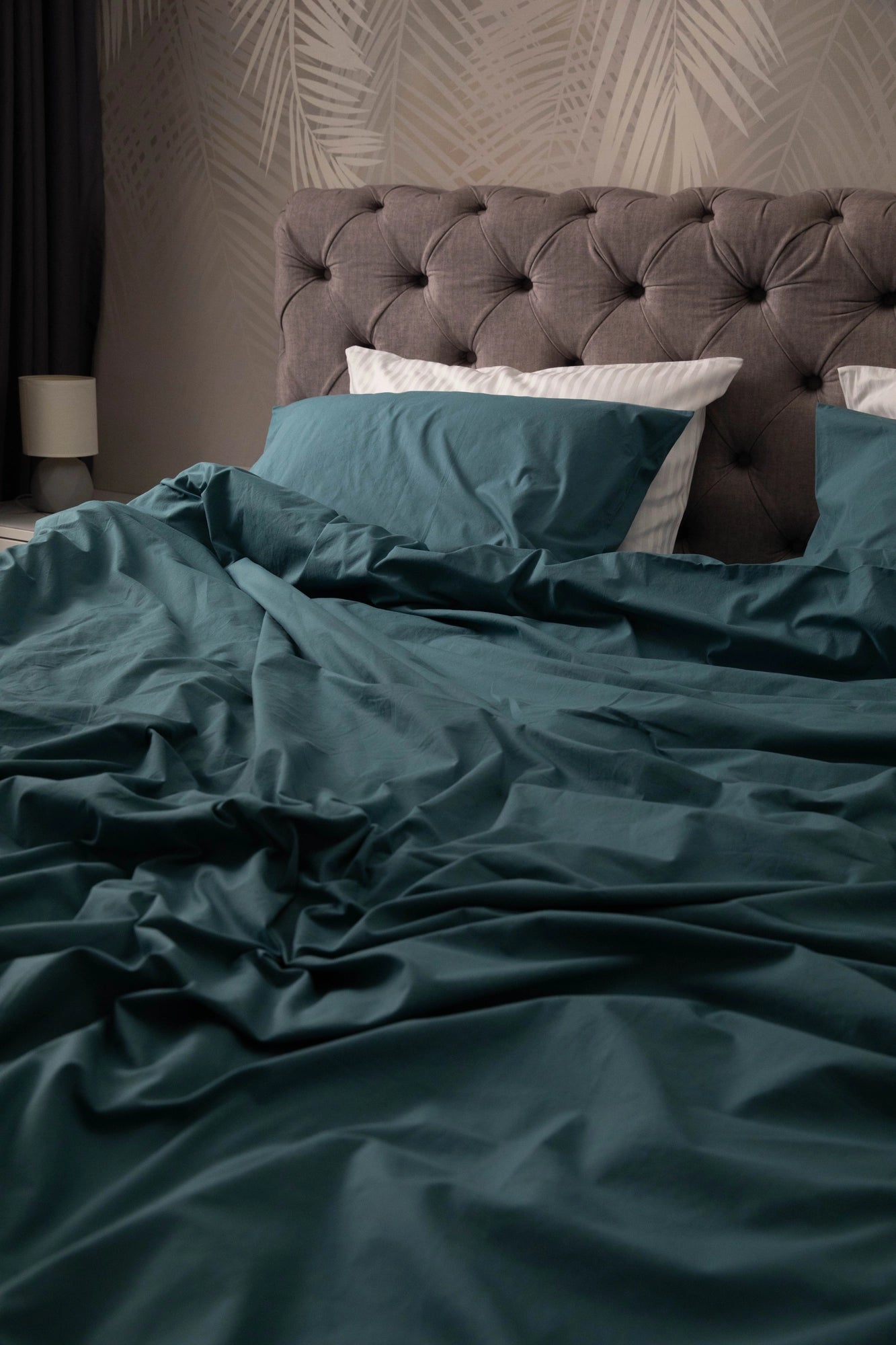 A styled bedroom with Supreme Rest’s teal bedding set, combining luxury comfort and custom eco-conscious design in every detail
