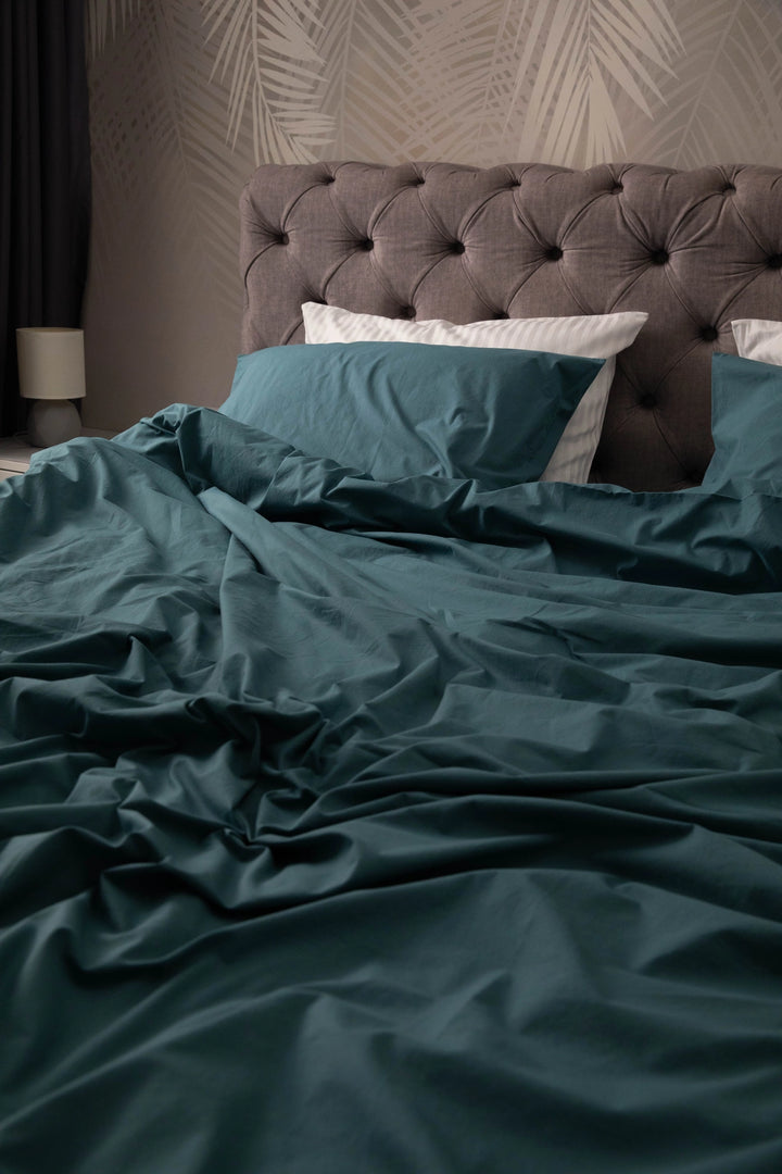 A styled bedroom with Supreme Rest’s teal bedding set, combining luxury comfort and custom eco-conscious design in every detail