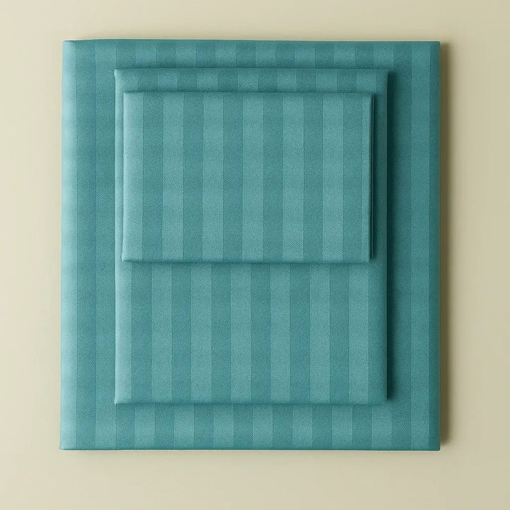 Supreme Rest turquoise striped bedding set neatly folded – eco-friendly custom sheets and pillowcases for stylish, sustainable sleep.