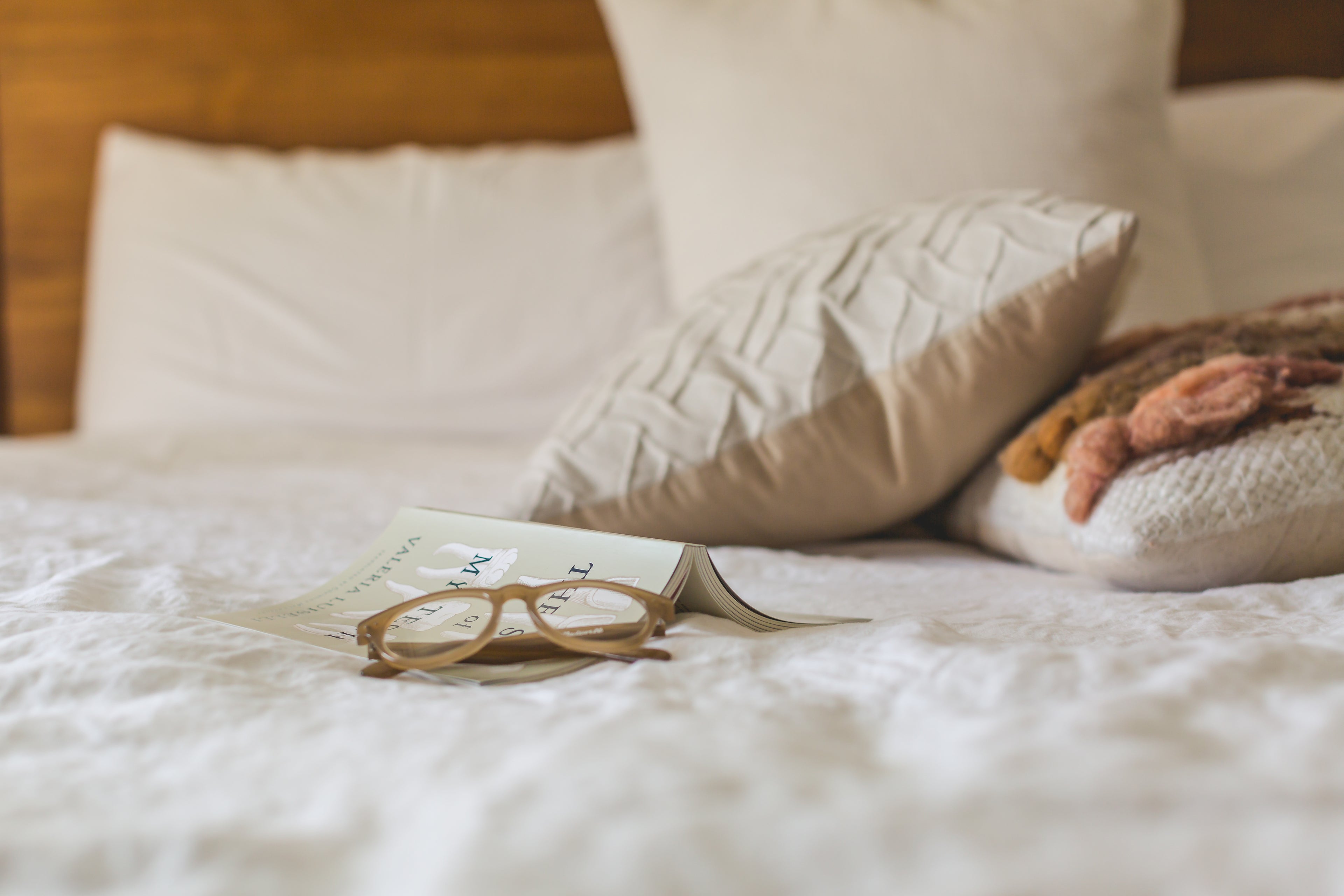 Supreme Rest linens and glasses. A scene of everyday coziness and comfort, emphasizing relaxation in bed.